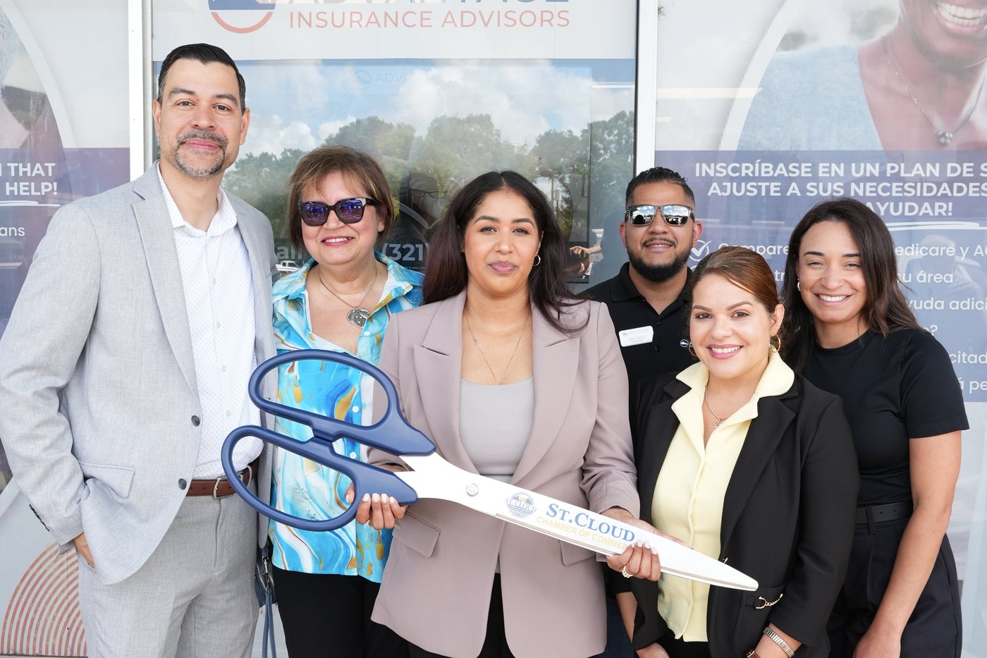 Advantage Insurance Advisors team with the St. Cloud Chamber of Commerce ceremonial scissors outside the St. Cloud office