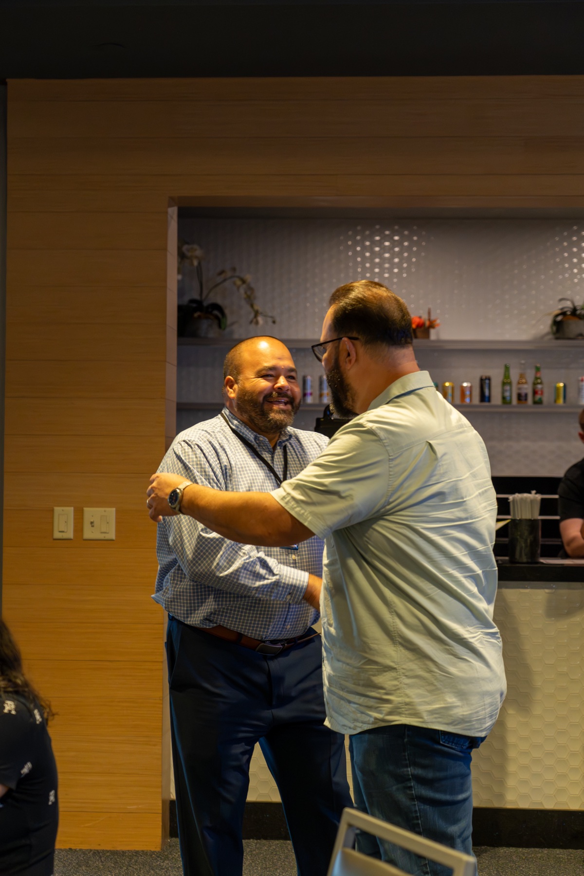 Two attendees sharing a friendly greeting at the 2026 AEP event